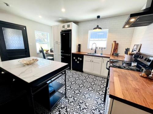 a kitchen with a black and white tile floor at Luxury - Pet Friendly, Farmhouse Bungalow DT Tampa in Tampa
