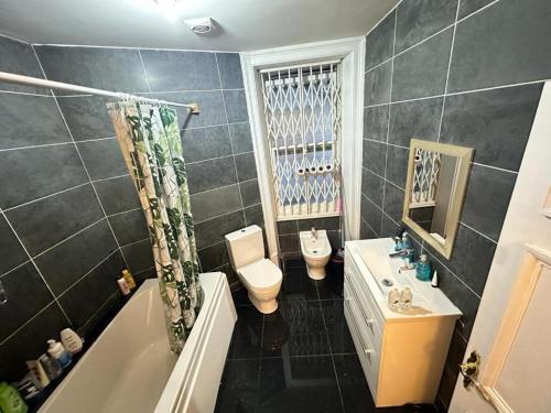 a bathroom with a tub and a toilet and a sink at 1 Step to Station! Double Room in Marylebone&Paddington, Central , #room name is tokyo# in London
