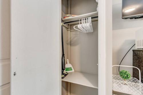 a closet with white walls and a white door at Downtown Olde Town Arvada- Across from light rail in Arvada