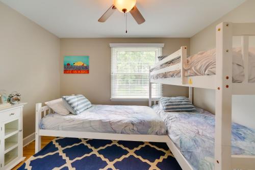 a bedroom with two bunk beds and a ceiling fan at Luxurious Bloomfield Hills Oasis with Pool and Spa! in Bloomfield Hills