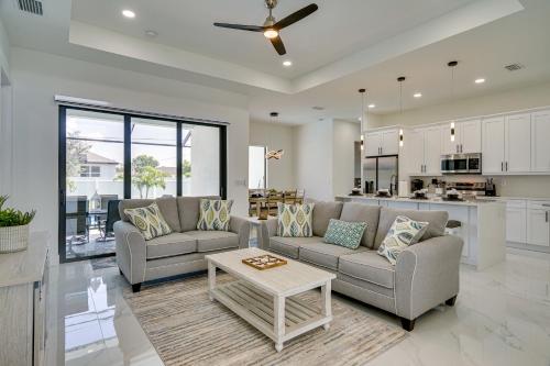 a living room with two couches and a table at Furnished Lanai and Private Pool Cape Coral Home in Cape Coral
