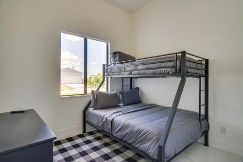 a bedroom with two bunk beds and a window at Furnished Lanai and Private Pool Cape Coral Home in Cape Coral