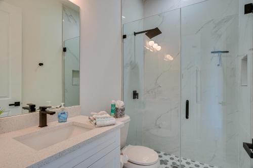 a bathroom with a shower and a toilet and a sink at Furnished Lanai and Private Pool Cape Coral Home in Cape Coral