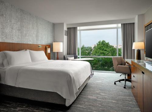 a hotel room with a bed and a large window at The Westin Austin at The Domain in Austin