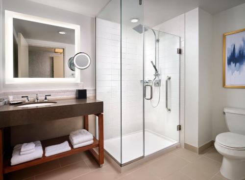 a bathroom with a shower and a sink and a toilet at The Westin Austin at The Domain in Austin