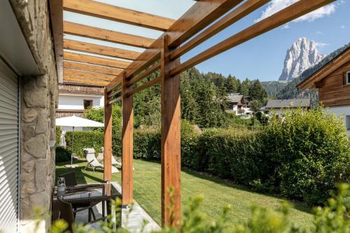 a patio with a view of the mountains from a house at Apartments Chalet Anna in Ortisei
