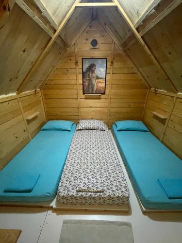 a small room with two beds in a cabin at Camping Albania-Secret Village Den in Sarandë