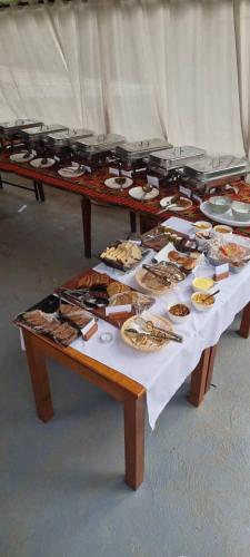 a table with plates of food on top of it at Nature Kigali in Kigali