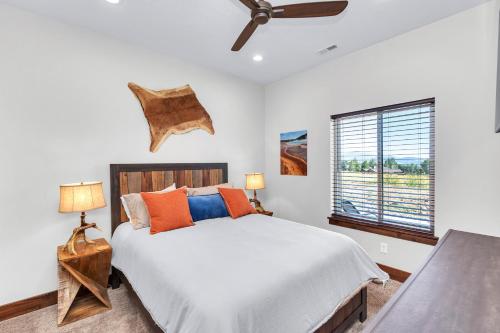 a bedroom with a bed with orange and blue pillows at Angels Landing in Eden