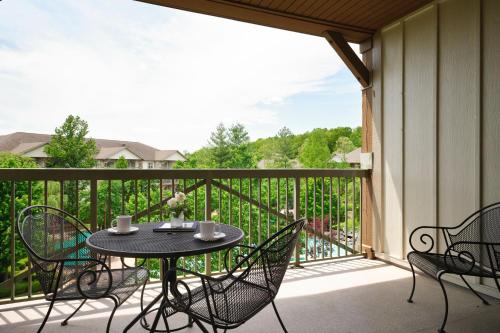 a patio with a table and chairs on a balcony at Marriott's Willow Ridge Lodge in Branson