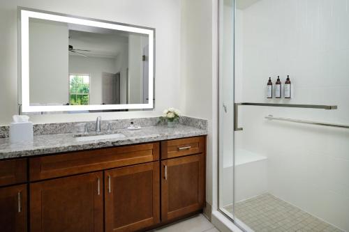 a bathroom with a sink and a shower with a mirror at Marriott's Willow Ridge Lodge in Branson