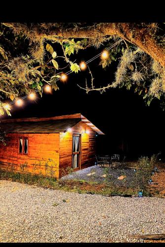 a log cabin with lights on top of it at Cabaña 1 santo cielo in Villa de Leyva