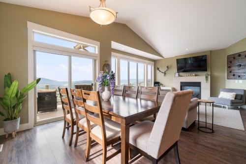 a dining room with a table and chairs and a fireplace at Stunning 5 bed house on Silver Star mountain in Vernon