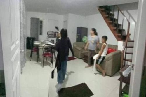 a group of people standing in a living room at James & Sohaib Two-Storey House @CamellaPrimaBXU in Butuan