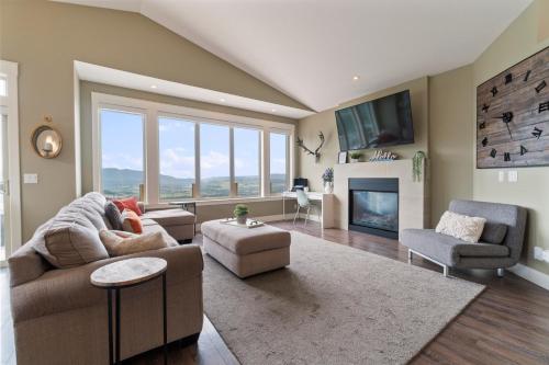 a living room with a couch and a fireplace at Stunning 5 bed house on Silver Star mountain in Vernon