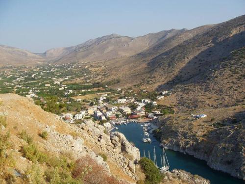 a view of a town on a river in a mountain at kalymnos Island Rina Vathy fiord house in Vathís