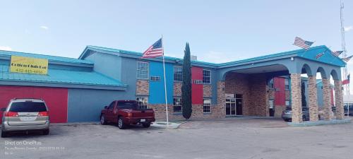 a red truck parked in front of a building at B&J HOTEL AND APARTMENTS in Pecos