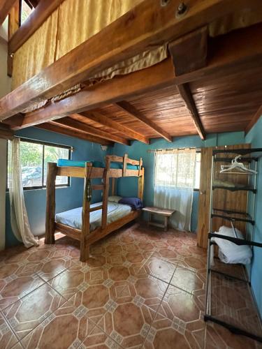 a bedroom with two bunk beds in a room at Aldos place in Playa Negra