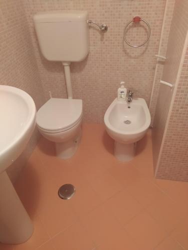 a bathroom with a toilet and a sink at Antico Borgo in Casole Bruzio