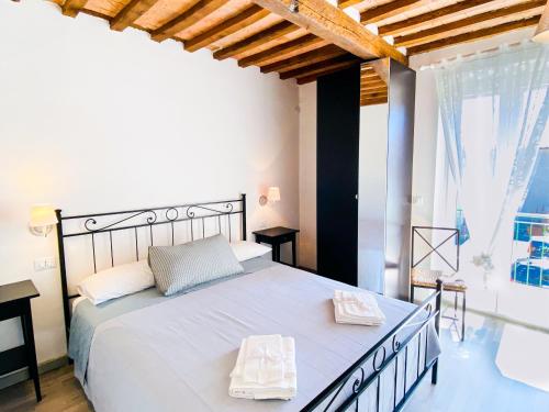 a bedroom with a large bed and a large window at Ca' di Leo in Santa Fiora