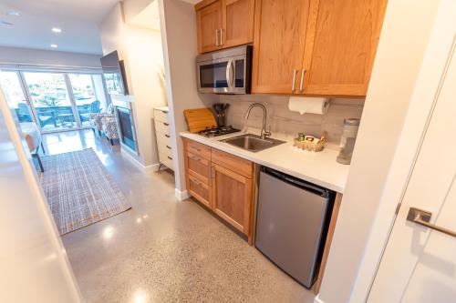 a kitchen with wooden cabinets and a sink at Baywood Inn Bed & Breakfast in Los Osos