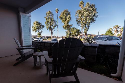 two chairs on a porch with a view of a parking lot at Baywood Inn Bed & Breakfast in Los Osos