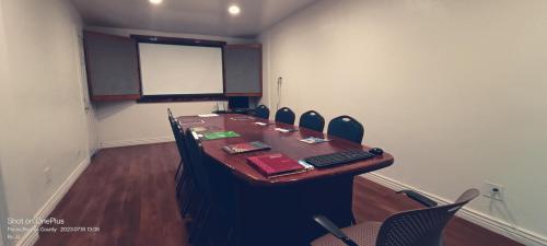 a conference room with a long table and chairs at B&J HOTEL AND APARTMENTS in Pecos