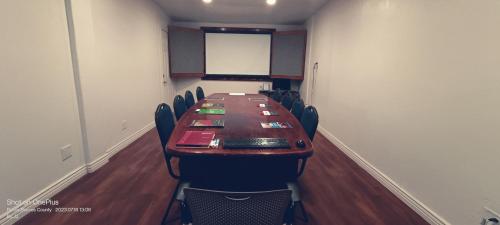 a conference room with a long table and chairs at B&J HOTEL AND APARTMENTS in Pecos