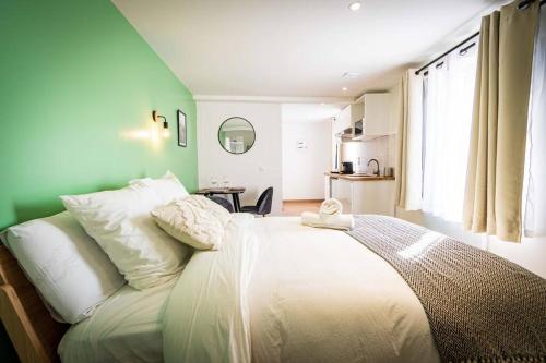 a bedroom with a large white bed with a window at L'Albatros 005 - Hypercentre * Cosy * Wifi in Saint-Quentin
