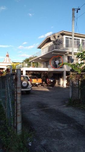 a building with cars parked in a parking lot at Nadi Town Newly Renovated 2nd Floor Suite with Large Terrace in Nadi