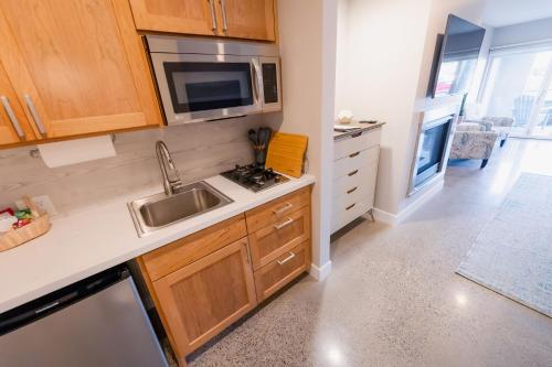 a kitchen with a sink and a microwave at Baywood Inn Bed & Breakfast in Los Osos