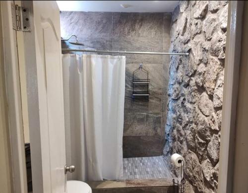 a bathroom with a shower with a white shower curtain at casa consulado in Ciudad Juárez