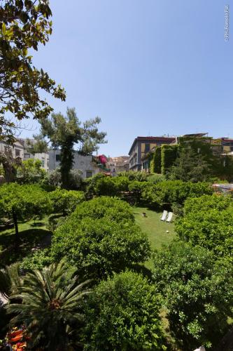 a park with trees and chairs on the grass at The Bellini House by House In Naples in Naples