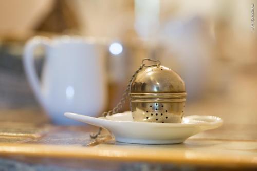 a helmet on a plate on a table with a cup at The Bellini House by House In Naples in Naples