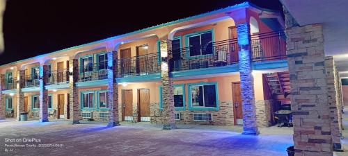 a building with a lit up facade at night at B&J HOTEL AND APARTMENTS in Pecos