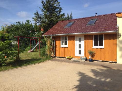 a house with a playground in front of it at Ferienwohnung Niesky in Niesky