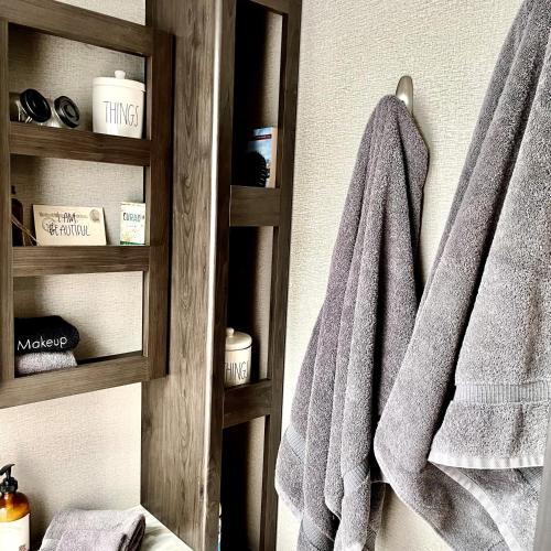 a towel hanging on a towel rack in a bathroom at Pet Friendly Graham Home Route 66 at The Mistletoe Farm in Graham