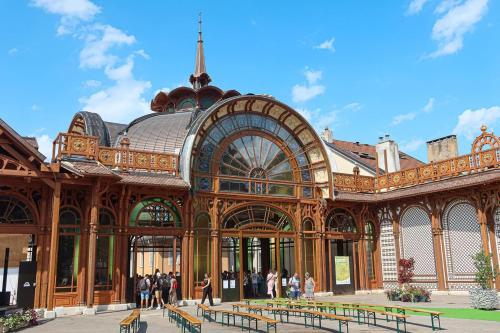 a large building with people standing outside of it at Hôtel Continental in Évian-les-Bains