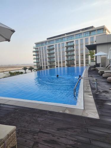 a large swimming pool in front of a building at ROYAL APARTMENTS DUBAI in Dubai