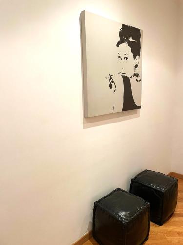 two black briefcases sitting next to a painting on a wall at Ammiragli Vatican Experience in Rome