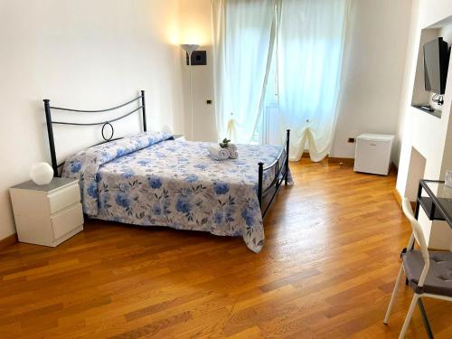 a bedroom with a bed and a wooden floor at Ammiragli Vatican Experience in Rome