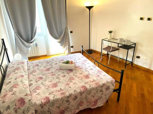 a bedroom with a bed with a flowered blanket at Ammiragli Vatican Experience in Rome