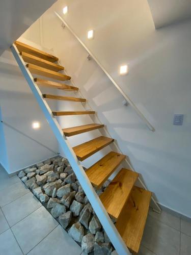 a staircase with wooden steps and rocks underneath it at Aire de las Sierras in Embalse