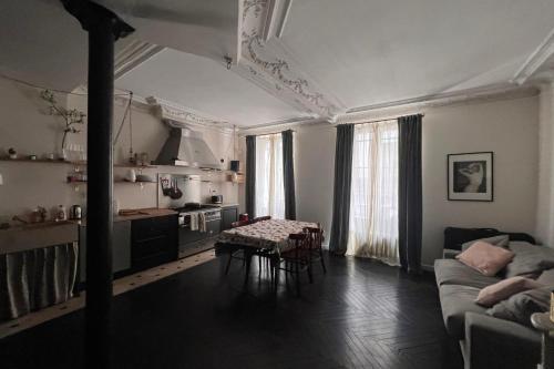 a living room with a couch and a table at Bright apartment - near Place Pigalle in Paris