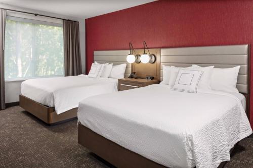a hotel room with two beds and a window at Residence Inn by Marriott Tuscaloosa in Tuscaloosa