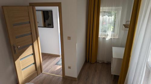 a door leading into a room with a mirror at Hubertus Rewal in Rewal