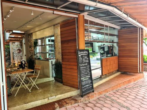 a restaurant with a chalkboard sign in front of it at Sisao Hotel-Café in Cuernavaca