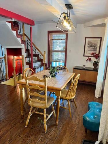 a dining room with a wooden table and chairs at Petite maison 2 bedrooms in Lévis