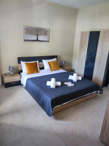 a bedroom with a large bed with towels on it at Grand View Apartment in Panagia