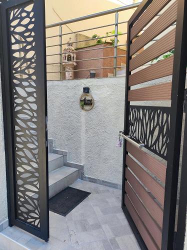 an open door to a stairway with a gate at Grand View Apartment in Panagia
